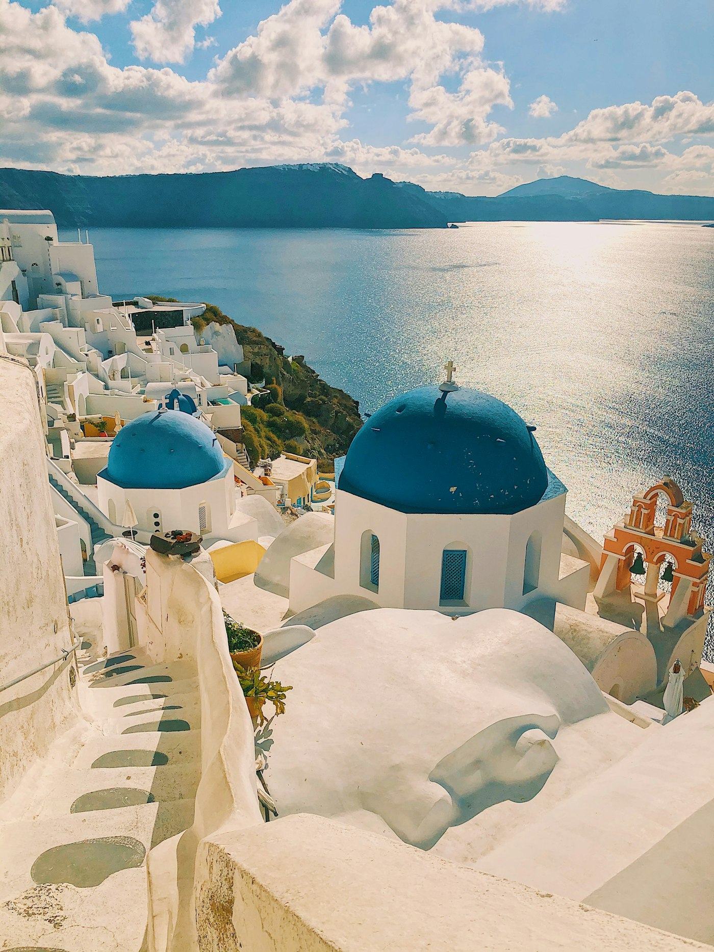 Whitewashed cliffside village and blue-domed churches overlooking the Aegean Sea in Santorini, Greece